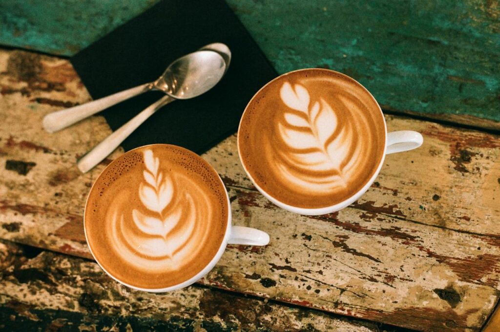 Two cute cups of delicious oat-milk cappuccinos,